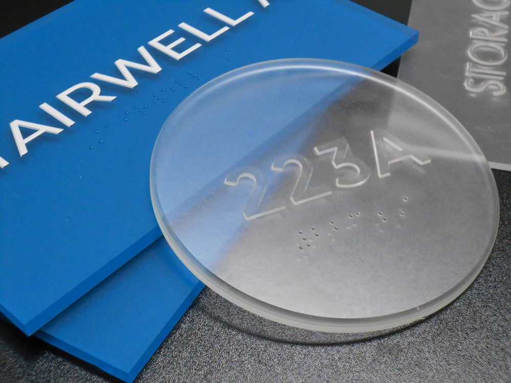 Clear thermoformed blank with tactile text and braille, showing unfinished thermoforming process before painting and finishing