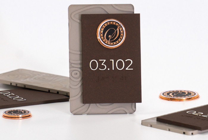 Dark bronze unit identification signs with copper medallion details for upscale apartment developments